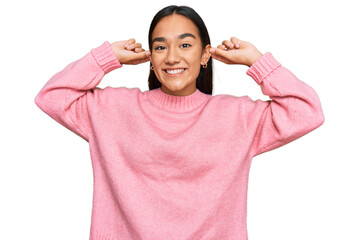 Poster - Young asian woman wearing casual winter sweater smiling pulling ears with fingers, funny gesture. audition problem