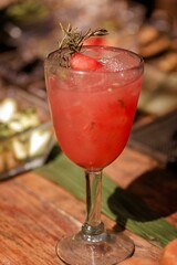 Sticker - Vertical shot of a strawberry cocktail in a glass decorated with strawberry and mint