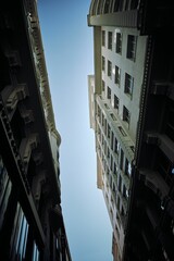 Poster - Vertical low angle of beautiful buildings against blue sky