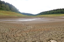 A Dried Up Empty Reservoir And Dam During A Summer Heatwave, Low Rainfall And Drought In Saxony, Germany, Talsperre Lehnmuehle