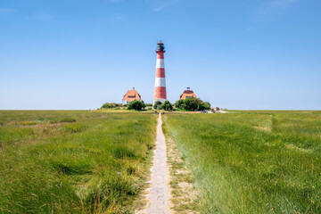 Wall Mural - pathway leading to the westerheversand lighthouse, westerhever, schleswig-holstein, germany