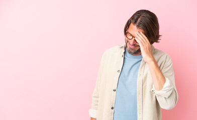 Wall Mural - Senior dutch man isolated on pink background laughing