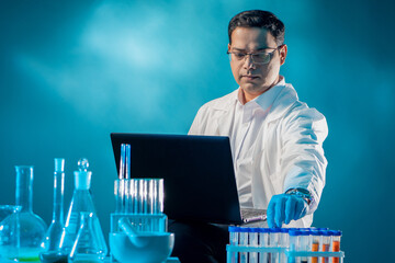 Poster - man works as chemist. chemistry laboratory staff. guy with laptop on lap. laboratory technician in f
