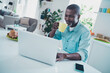 © deagreez - Portrait of positive peaceful man enjoy fresh hot coffee use wireless netbook coworking kitchen indoors