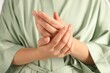 © New Africa - Woman applying luxury cosmetic cream onto hand, closeup