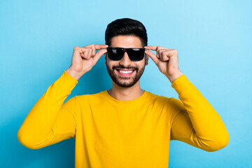 Wall Mural - Photo of attractive confident guy dressed yellow pullover arms dark eyewear smiling isolated blue color background