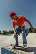 © LIGHTFIELD STUDIOS - young and stylish skater jumping from ramp in skate park