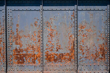 Rusty Metal Background - Old Rundown Grey And Blue Peeling Paint Reveal Patterns On A Rusted Metal Surface.
