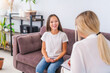 teenage patient talks to a psychologist at home or in the office, expressing emotions. A positive teenage girl listens to a psychologist at a meeting, thinking about her problems. Successful therapy.
