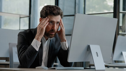 Caucasian bearded 40s middle-aged businessman worker employee man typing laptop feel failure upset with lost of information online error stressed look at computer screen suffer from headache pressure