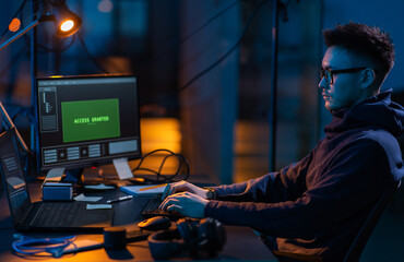 Poster - cybercrime, hacking and technology concept - male hacker in dark room writing code or using computer virus program for cyber attack