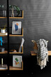 © Syda Productions - interior and home decor concept - book shelf with art and decorations over black background
