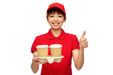 Sticker - service and job concept - happy smiling delivery woman in red uniform with takeaway hot drinks in disposable coffee cups showing thumbs up over white background