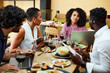 © chika_milan - Businesspeople have team building in a restaurant during lunch.
