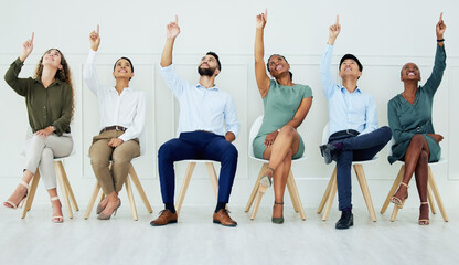 Aufkleber - Business, team and office in teamwork collaboration sitting and pointing up together in solidarity at the workplace. Group of creative people in diversity with hands, finger gesture for work success.