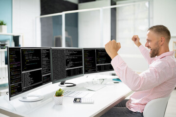 Excited Programmer Using Multiple Computer Screens