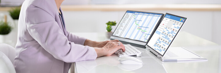 Poster - Employee Working On Calendar Schedule