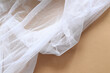 white tulle fabric on brown paper