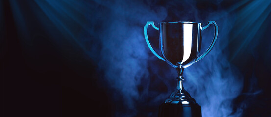 silver trophy award competition with smoke in the dark , blue tone