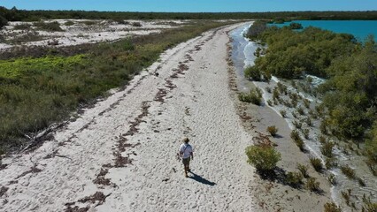 Wall Mural - Aerial landscape view of Australian man walking on empty wild beach in Cape Leeuwin in the Kimberley region, Western Australia