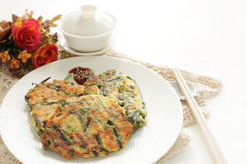 Wall Mural - Korean food, leek and tofu Jeon Pancake on dish with copy space for nutrition cooking image