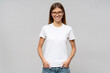 © Damir Khabirov - Young woman in casual white t-shirt standing with hands in pockets, template or mockup for logo
