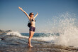 © diignat - Cheerful young woman enjoying freedom on vacation on the sea side