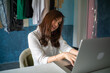 © themorningglory - Busines asian woman online sell use laptop and smartphone deal with customer