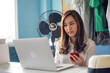 © themorningglory - Busines asian woman online sell use laptop and smartphone deal with customer