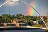 Rainbow behind the Gateshead Millennium Bridge in Newcastle, the UK on a stormy spring day