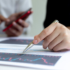 Wall Mural - Accountants and financiers are brainstorming the analysis of revenue performance with stock graphs at meetings, Analysis of real estate investment and income tax data concept.