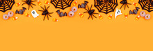 Halloween Top Border Of Scattered Candy And Decor. Above View Over An Orange Banner Background With Copy Space.