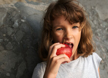 Child Eating Red Apple Close Up 