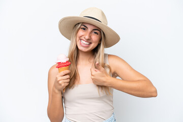 Wall Mural - Young caucasian woman with a cornet ice cream isolated on white background with thumbs up because something good has happened