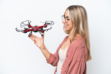 Wall Mural - Woman holding a drone over isolated background with happy expression