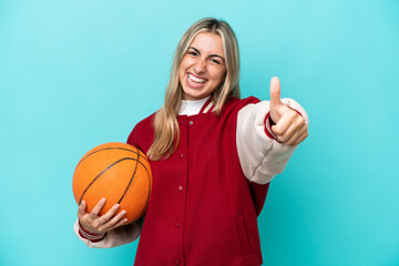 Wall Mural - Young caucasian basketball player woman isolated on blue background giving a thumbs up gesture