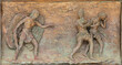MONOPOLI, ITALY - MARCH 6, 2022: The bronze relief  Expulsion of Adam and Eve from Paradise the  on the gate of church Chiesa di Sacro Cuore by Wolfgang Stempfele from year 2002.