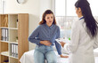 © Studio Romantic - Female medical specialist consults young female patient who complains of abdominal pain. Woman experiences abdominal discomfort due to menstrual pain, pancreatitis, gastritis or diarrhea.