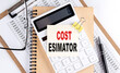 COST ESTIMATOR word on sticky with clipboard and notebook, business concept
