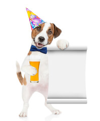 Poster - Happy Jack russell terrier puppy wearing tie bow and party hat holds  beer and empty list. isolated on white background
