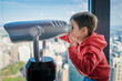 © Austockphoto - Cute 4 year old mixed race boy plays with a telescope in Sydney Centrepoint Tower