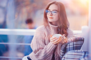 girl spring cafe portrait, happy young model posing with a cup of coffee, spring look