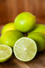 Pile Of Fresh Lime Citrus Fruit On Wooden Board