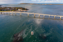 Aerial View Of A Narrow Bridge Over A Wide Tidal Inlet With A Warning Beacon
