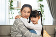 © anon - Happy Asian mother and cute little daughter having fun while playing and hugging at home in living room. Happy love family concept.