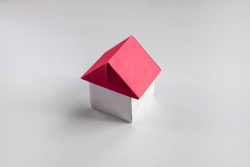 Wall Mural - White and red paper house origami isolated on blank background