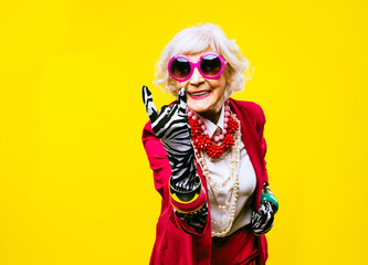 cool and stylish senior old woman with fashionable clothes - funny colorful portrait of elderly fema