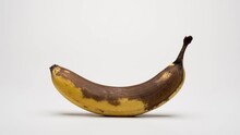 Ripening And Decaying Timelapse Footage Of A Banana On A White Background With A Soft Shadow.