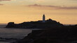 Leuchtturm auf Felseninsel im Sonnenuntergang