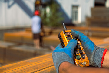 Closeup of hands using remote control of gantry crane